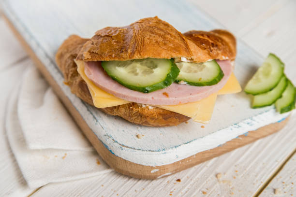 istock Croissant with ham, cheese and cucumber 697647010