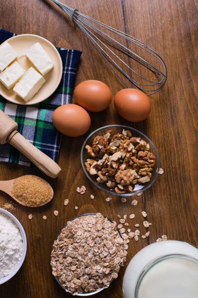 istock Ingredients and utensils for baking on wooden table vertical photo 697651890