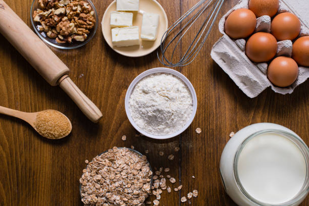 istock Ingredients and utensils for baking on wooden table 697654574