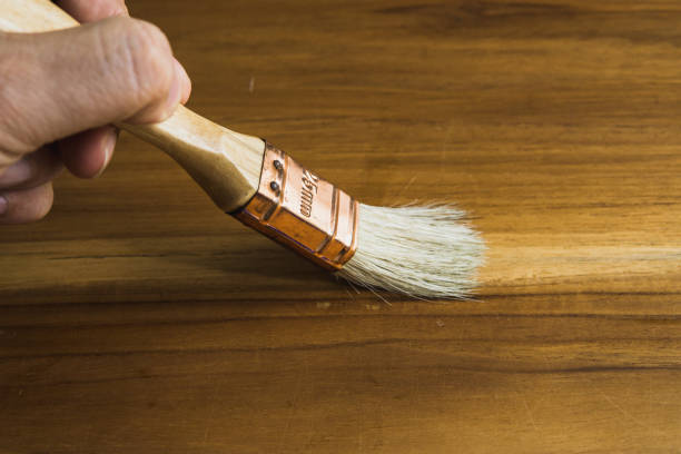 istock paint with paint brush on wooden table 697658014
