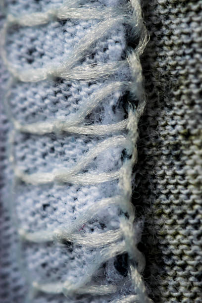 istock White and gray stitches wool textile pattern macro, clothing 697661334