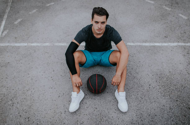 istock Man sitting with basketball 697671076