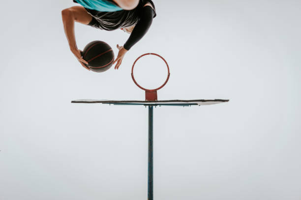 istock Street basketball player doing a slam dunk 697674510