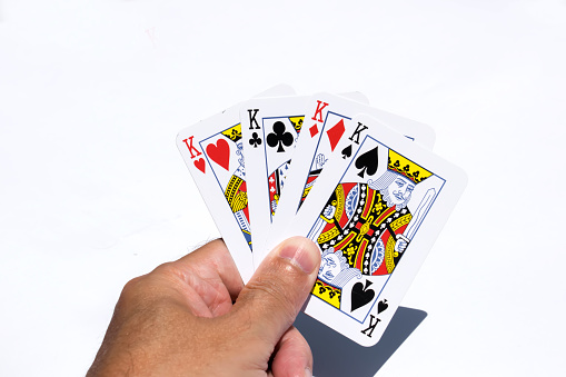 Poker cards on white backgrounds.Four kings in hand