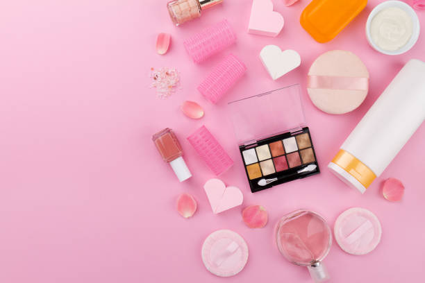 istock Beauty Spa Feminine Concept. Different Make Up Beauty Care Essentials Cosmetics on Flat Lay Pink Background. Top View. 697674588