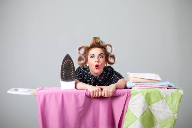 Funny housewife ironing stock photo