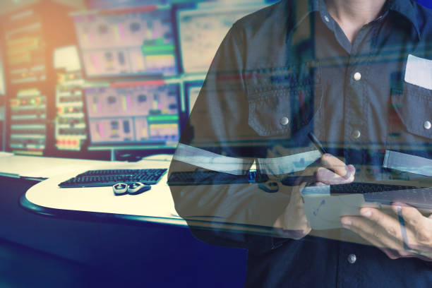 istock Double exposure of  Engineer or Technician man in working shirt  working with tablet in control room of oil and gas platform or plant industrial for monitor process, business and industry concept. 697678570