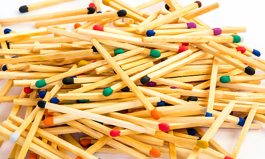 Multicolored wooden matches on the  white background