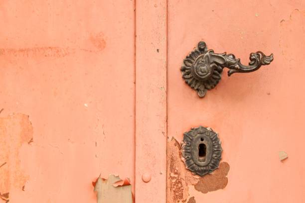 istock An old metal handle on a sheet metal door. 697691862
