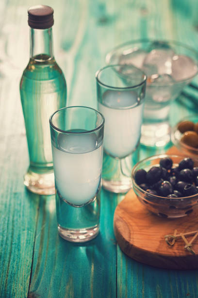 Greek Ouzo and Olives Favorite Greek summer drink Ouzo,flavor liquor made with the anise plant , served with Calamata Olives. serbian raki stock pictures, royalty-free photos & images