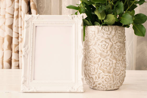 istock White Frame Mock Ups, Digital MockUp, Display Mockup, Sea Styled Stock Photography Mockup, Colorful Desktop Mock Up. Rustic vase with orange roses and yellow chrysanthemums. White background, empty place, copy space. Vintage tinted 697702702