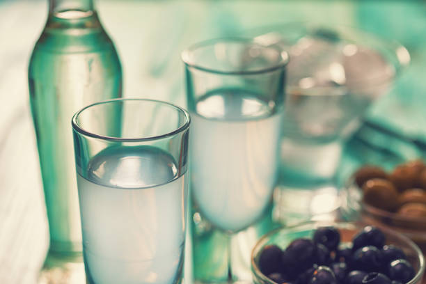 Greek Ouzo and Olives Favorite Greek summer drink Ouzo,flavor liquor made with the anise plant , served with Calamata Olives. serbian raki stock pictures, royalty-free photos & images