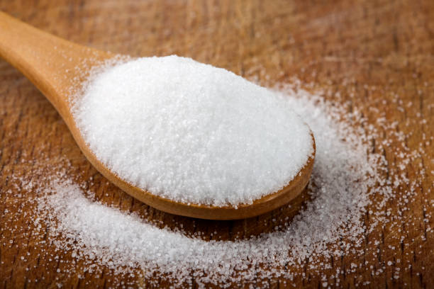 istock Wooden spoon filled with fine salt 697702980