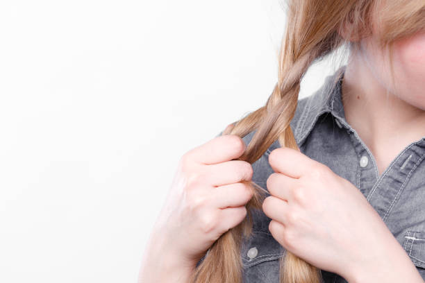 istock Blonde woman making braid tress. 697706224