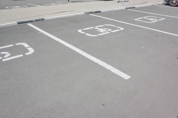 istock Disabled parking sign on asphalt. handicapped sign parking spot. 697708820