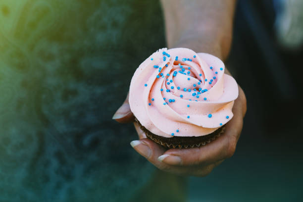 istock Woman holding a cupcake 697713244