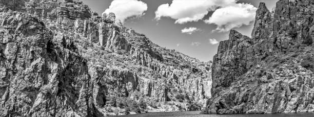 The rapid current of the Ardeche river in a rocky canyon in France, monochrome