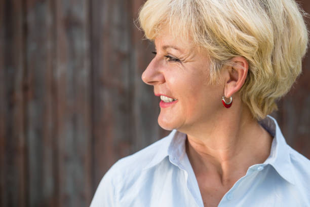 istock Nostalgic senior woman looking away with a smile while daydreami 697716634