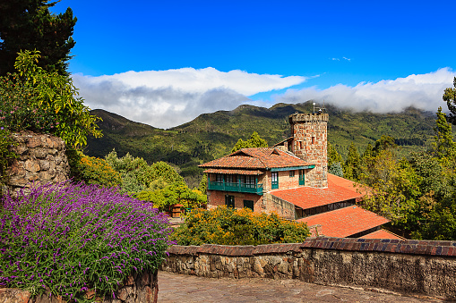 Bogota, Colombia - Looking from the Andean Peak of Monserrate in the Colombian Capital city of Bogota, towards other mountain peaks on the Andes. To the right of the image is the Rack Railway station on Monserrate. It is public property. The image was also shot from a public area. The elevation on top of Monserrate is 10,341 feet above mean sea level. Photo shot in the bright afternoon sunlight, on a clear day; horizontal format. No people. Copy Space. Camera: Canon EOS 5D MII. Lens: Canon EF 24-70 F2.8L USM.