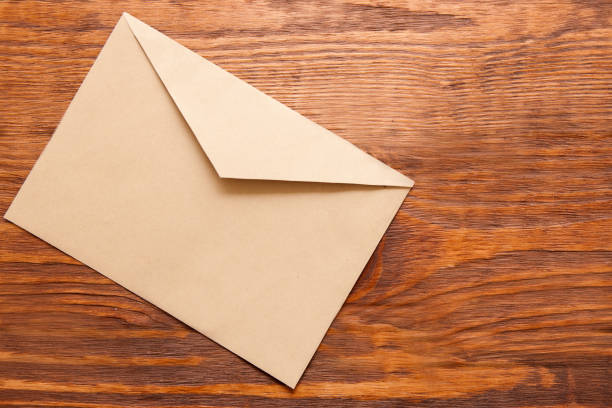 istock Blank brown envelope on wooden background 697719814