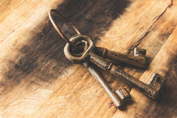 istock Three old (vintage) keys on a wooden background. 697722078