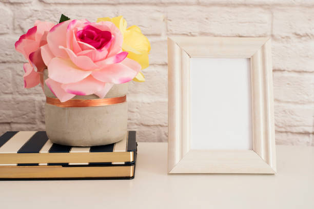 istock Frame Mockup. White Frame Mock up. Cream Picture Frame, Vase With Pink Roses on Stripe Notebooks. Product Frame Mockup. Wall Art Display Template, Brick Wall 697725708