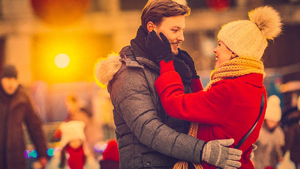 istock Young couple on a date at a public ice rink 697725978
