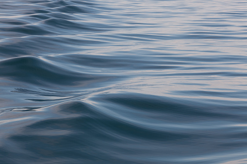 Abstract image of rolling bow waves made by a ship in the ocean