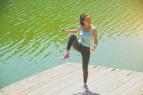 istock Woman Stretching Near River 697729036
