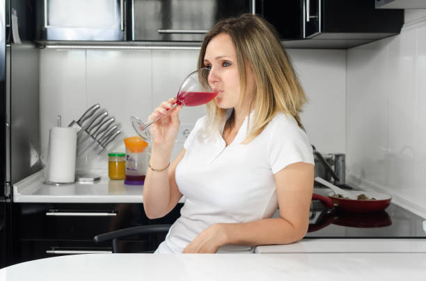 istock successful beautiful girl drinking red wine 697732648