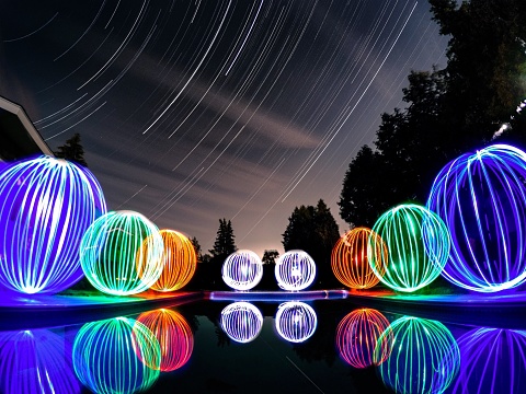 Timelapse of the stars with some light painted orbs around the pool. Taken in my back yard, Bay City, Michigan.