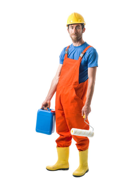 istock Portrait of Manual Worker Wearing Protective Clothes And Holding Paint Roller 697735404
