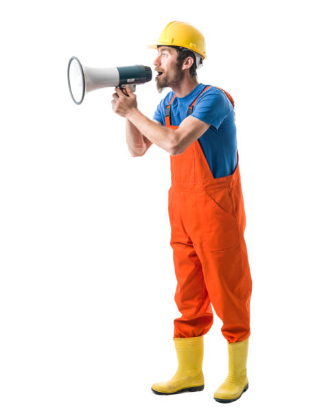 istock Adult Worker With Hardhat Shouting Through Megaphone 697735464