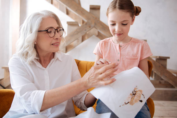 istock Nice pleasant woman helping her granddaughter 697735990