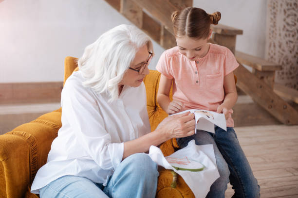 istock Pleasant delighted woman teaching to embroider 697736134