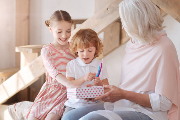 istock Curious happy children looking at their presents 697739048