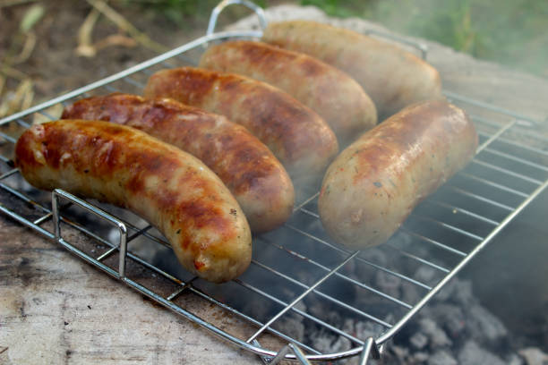 istock Pork sausage fry on charcoal with smoke 697739626