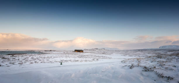 Found the beautiful tangerine abandoned cabin driving the majestic mountainn frozen snowcapped mountain road in East Iceland