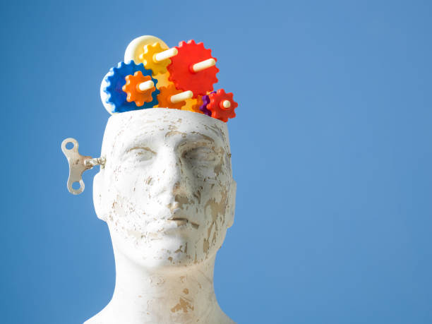 istock Multicolored Gears In Mannequin Head On Blue Bakcground 697752586