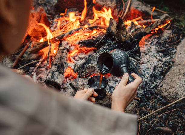 istock Woman makes a coffee on campfire 697757010
