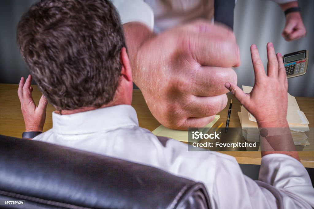 Big Boss Fist Slamming Down on Male Worker Desk - Work Stress Pressure Series. Bullying Stock Photo