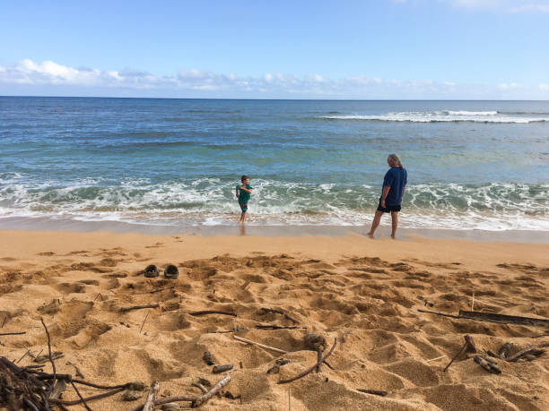 istock Grandfather at the ocean with grandson 697770092
