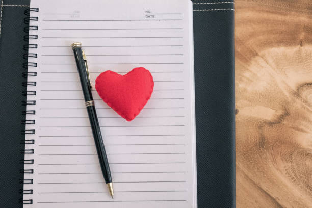 istock red heart and pen on notebook. love backdrop 697770592