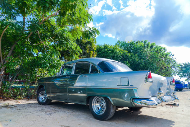 istock Vibrant old car parked on beach in Cuba 697776838