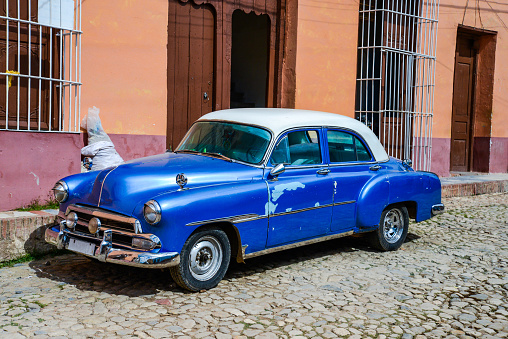 Vibrant vintage car on colonial street in Cuba.