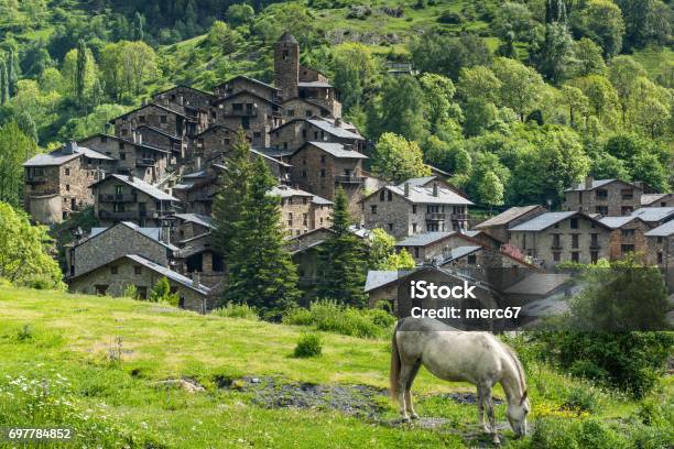 Horse Grazing In Front Of Pyrenees Village In Andorra Stock Photo - Download Image Now