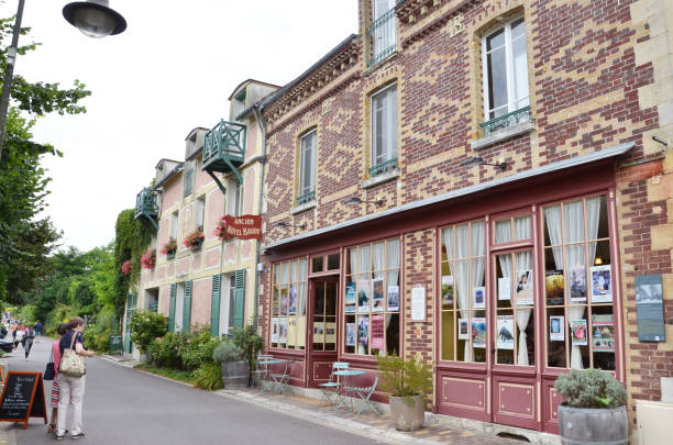 Hotel Baudy, Giverny GIVERNY, FRANCE - AUG 5:  Visitors look at the Hotel Baudy in Giverny, France on August 5, 2016. Painter Claude Money and friends frequented this hotel from 1887 to 1914. foundation claude monet photos stock pictures, royalty-free photos & images
