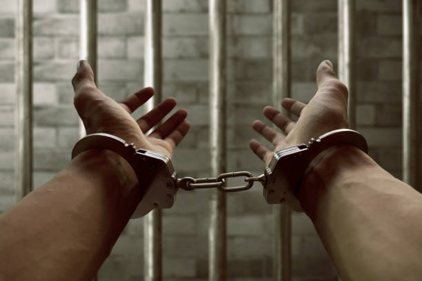 istock Hands of prisoner in handcuffs 697791414