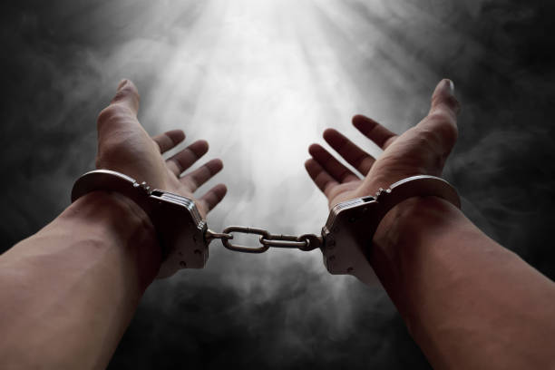 istock Hands of prisoner in handcuffs 697791416