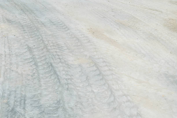 istock Closeup surface concrete floor with tire tracks textured background 697794046